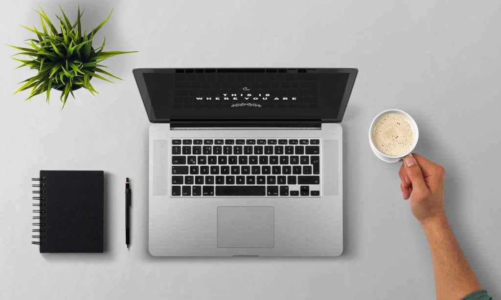 start an online business: laptop with coffee and notebook beside it